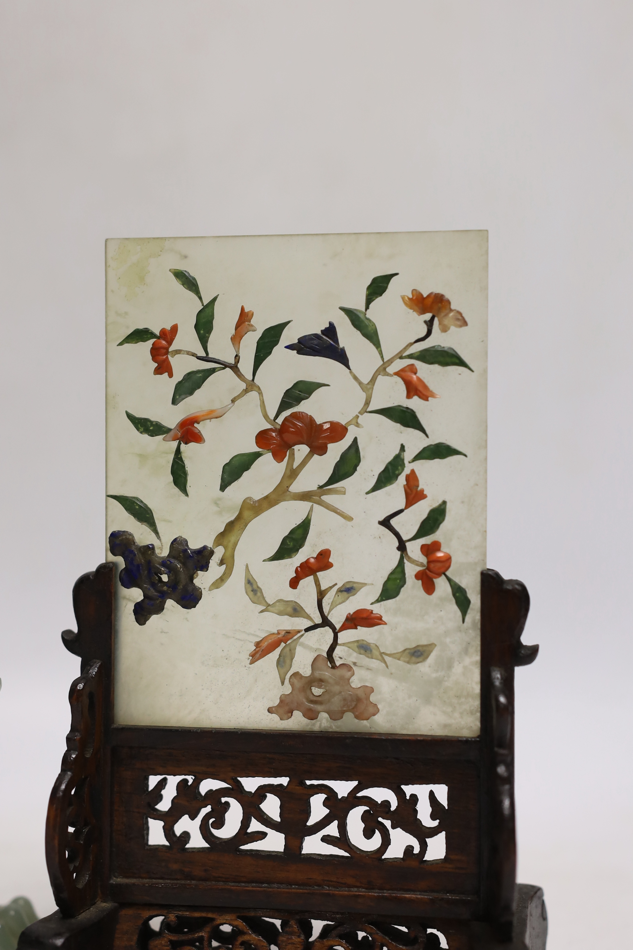 An early 20th century Chinese hardstone, lapis lazuli, coral and hardwood table screen together with a Chinese green jade lion dog, tallest 18cm